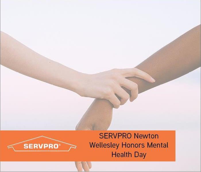 Hands in background with orange text and SERVPRO logo 